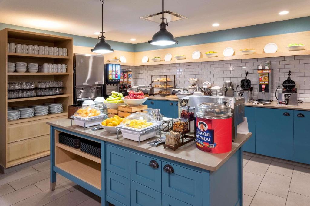 a kitchen with blue cabinets and food on a counter at Country Inn & Suites by Radisson, Fargo, ND in Fargo