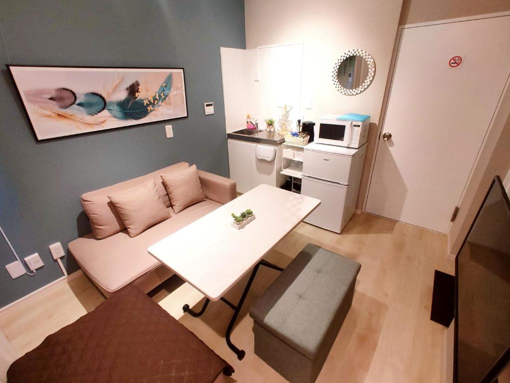 a small living room with a table and a kitchen at MaMe Inn, - Vacation STAY 80189v in Saitama