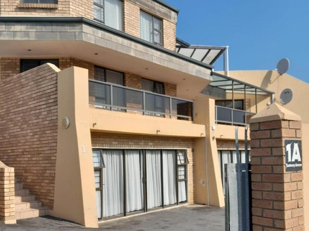 a building with two garage doors and a balcony at Buffalo View Lodge in East London