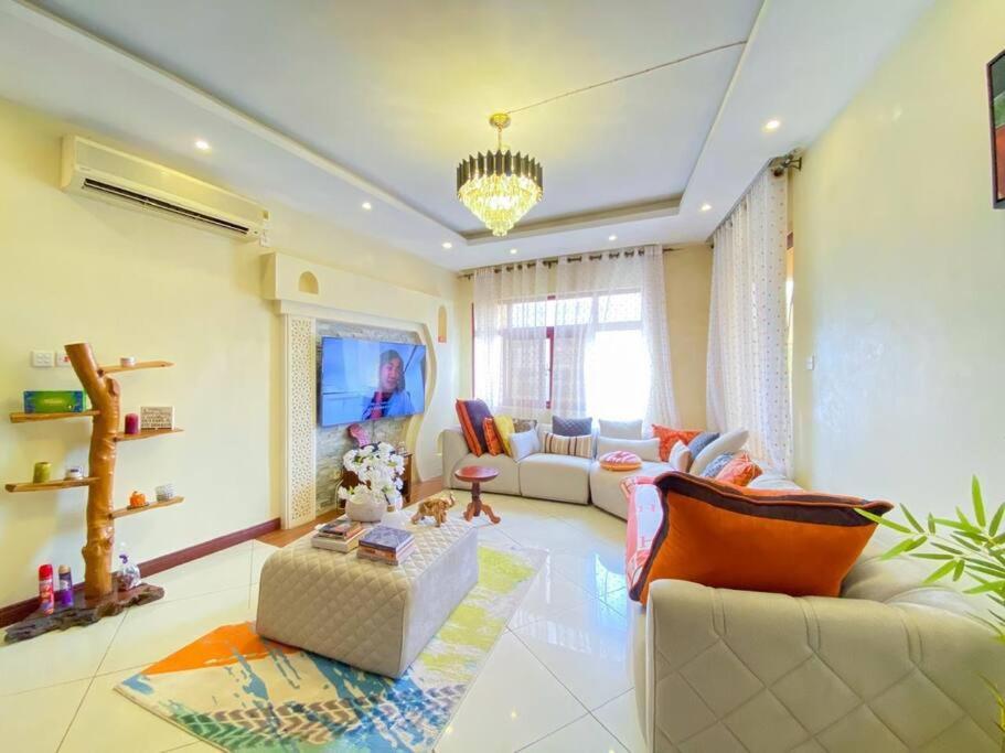 a living room with a couch and a table at Two Bedroom Apartment in Mombasa