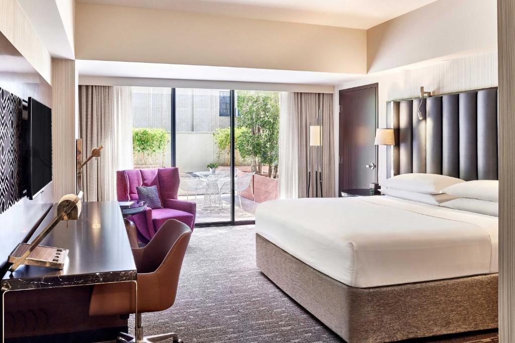 a hotel room with a bed and a desk at Sheraton Grand Los Angeles in Los Angeles