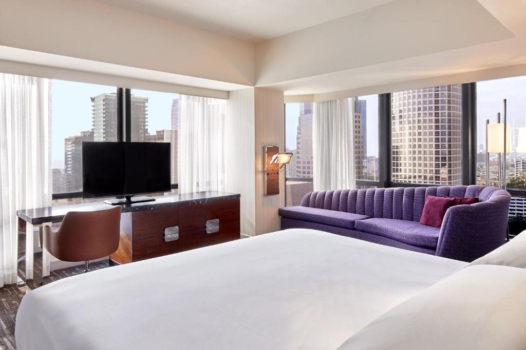 a hotel room with a bed and a large window at Sheraton Grand Los Angeles in Los Angeles