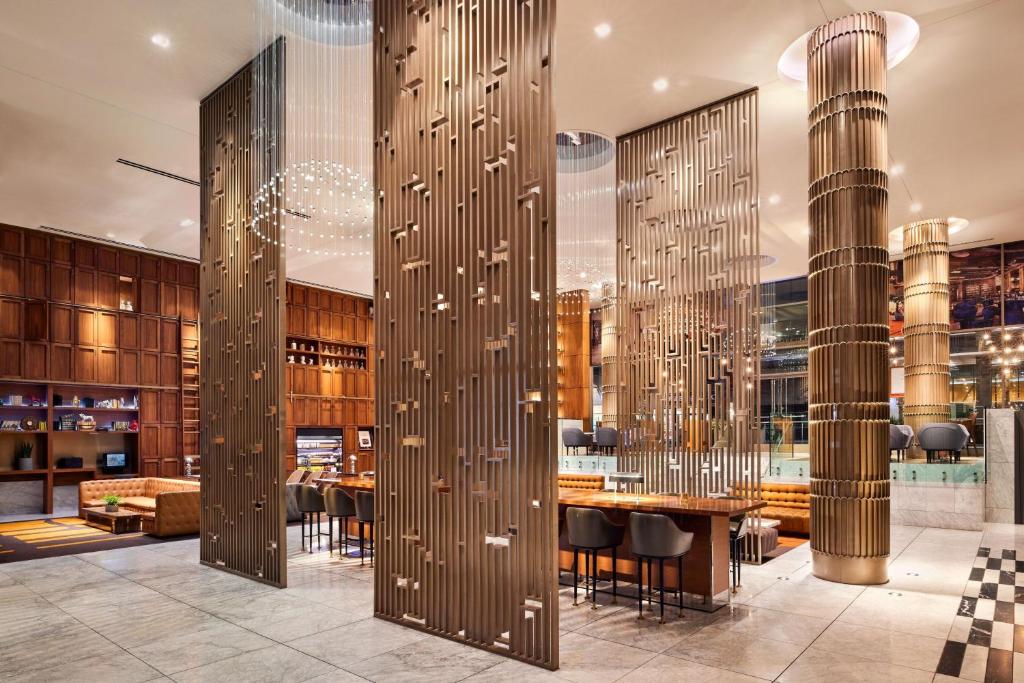 a restaurant with tables and chairs in a building at Sheraton Grand Los Angeles in Los Angeles