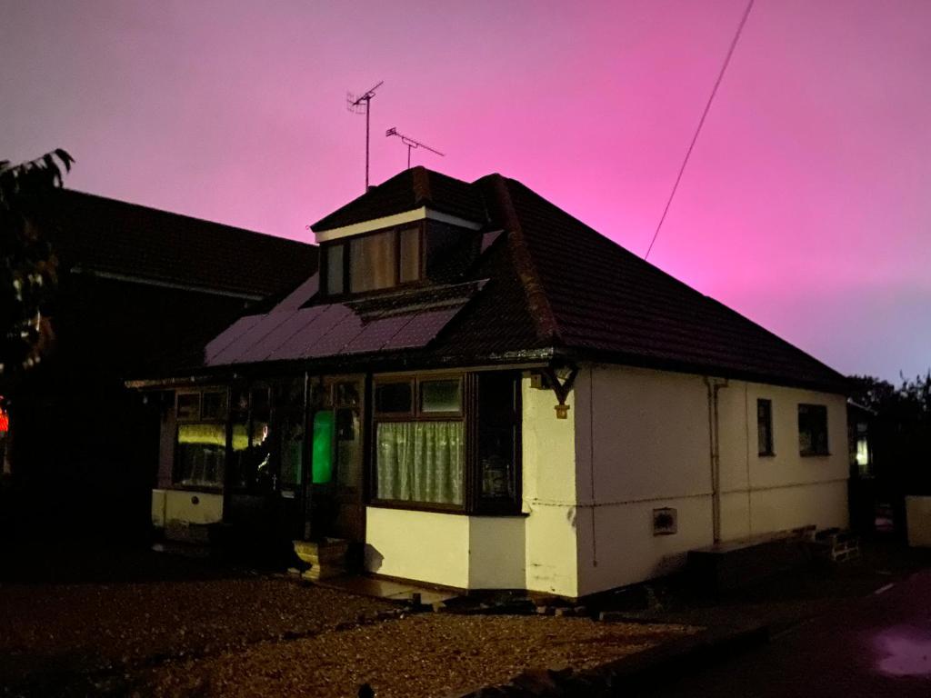 a small white house with a purple sky at Bungalow in Badsey, north of Cotswolds in Badsey