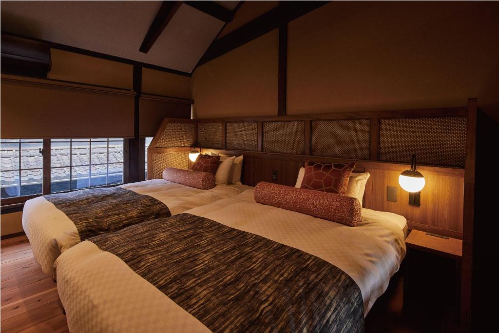 Postel nebo postele na pokoji v ubytování Tomonoura Shiomachi Hotel
