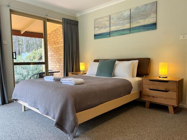 a bedroom with a bed with two lamps and a window at Mansfield Retreat - In Town - Margaret River in Margaret River Town