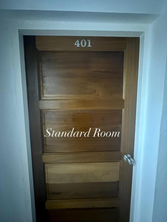 a sign on the door of a standard room at Surin Bay Inn in Surin Beach
