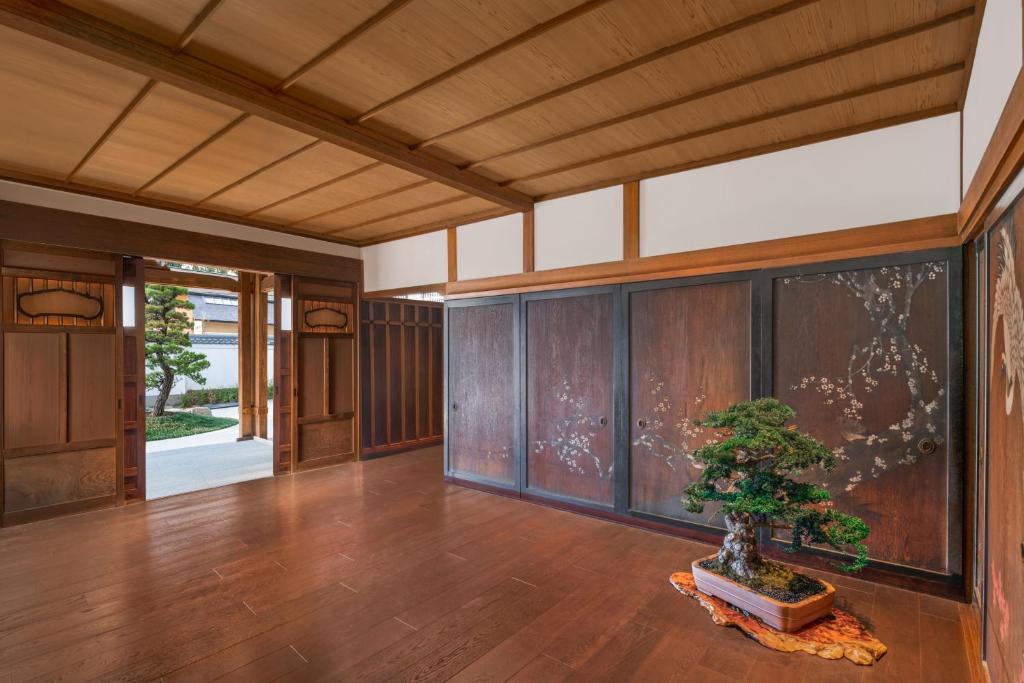 a plant in a vase in a room with wooden walls at Shisui, a Luxury Collection Hotel, Nara in Nara