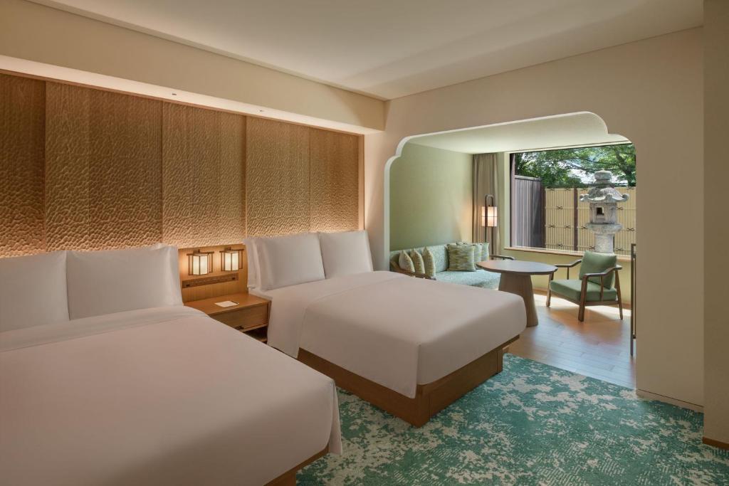 a hotel room with two beds and a window at Shisui, a Luxury Collection Hotel, Nara in Nara
