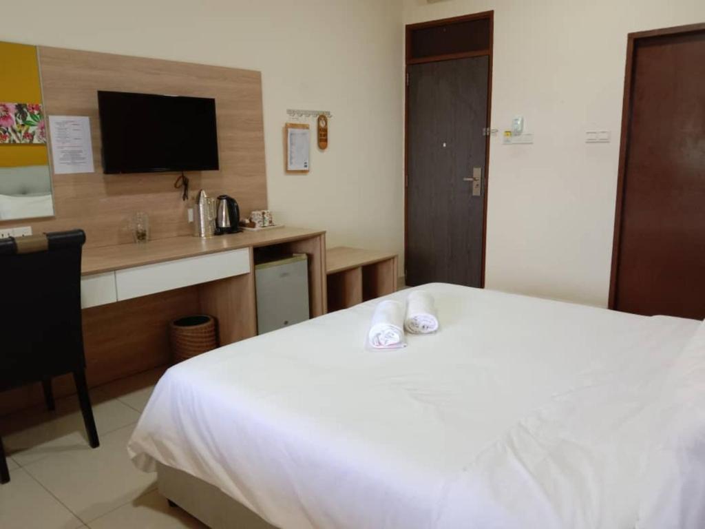 Postel nebo postele na pokoji v ubytování Seaside Travellers Inn