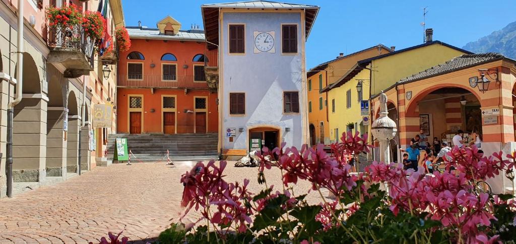 a cobblestone street with colorful buildings and flowers at Appartamento Uso Turistico Entracque in Entracque