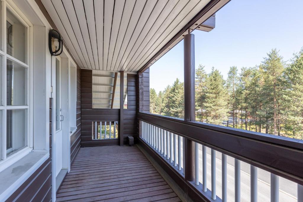 a porch of a house with a wooden deck at Levillenet Glacier Alpine Chalets at Levi Centre in Levi