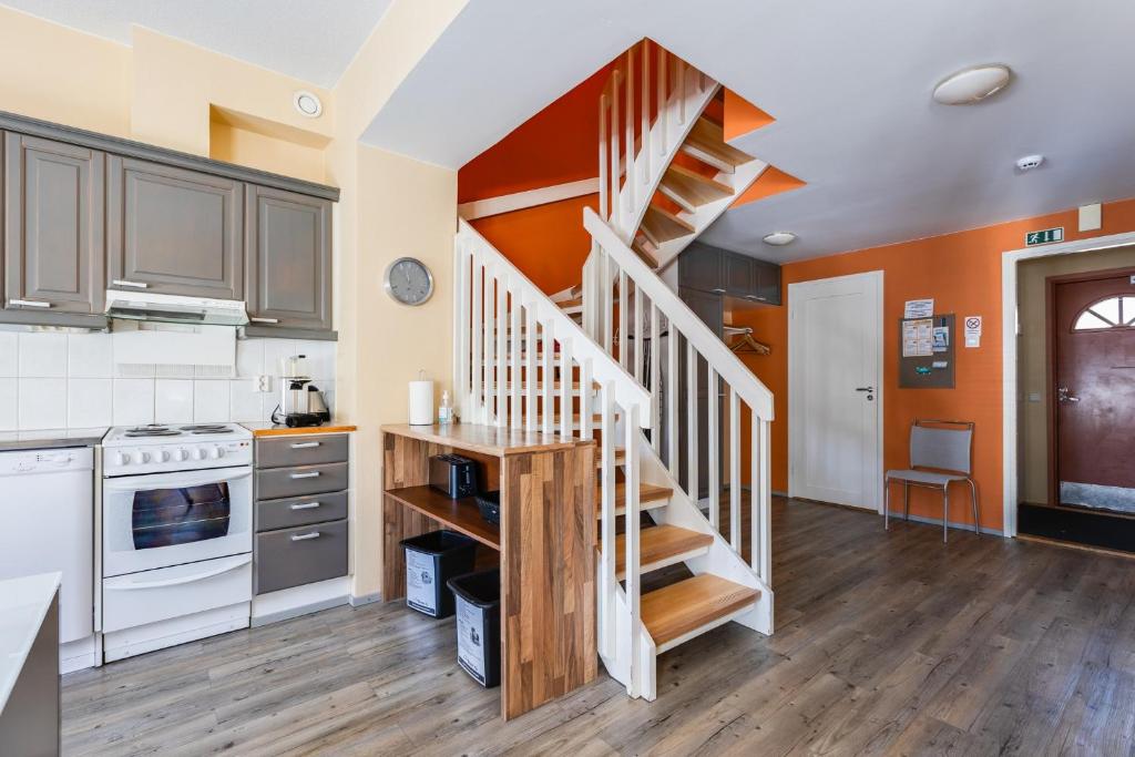 a kitchen with a spiral staircase in a house at Levillenet Glacier Alpine Chalets at Levi Centre in Levi