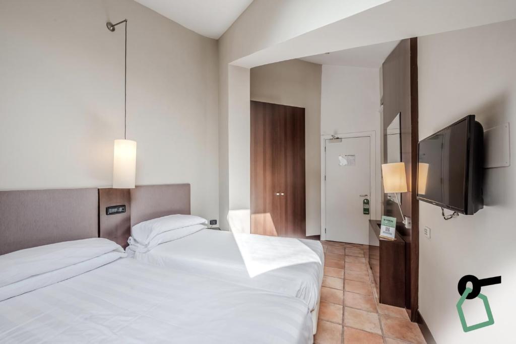 Postel nebo postele na pokoji v ubytování HOTIDAY Room Collection - Roma Cornelia
