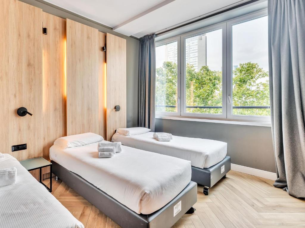 Postel nebo postele na pokoji v ubytování B&B Hotel Milano Aosta