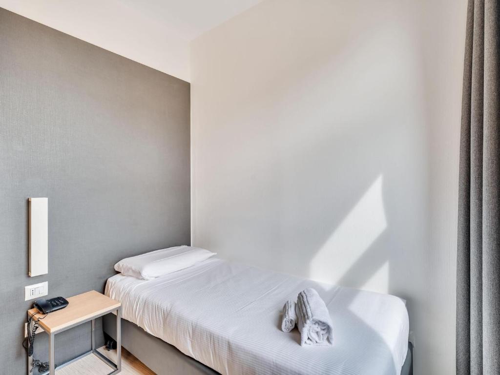 Postel nebo postele na pokoji v ubytování B&B Hotel Milano Aosta
