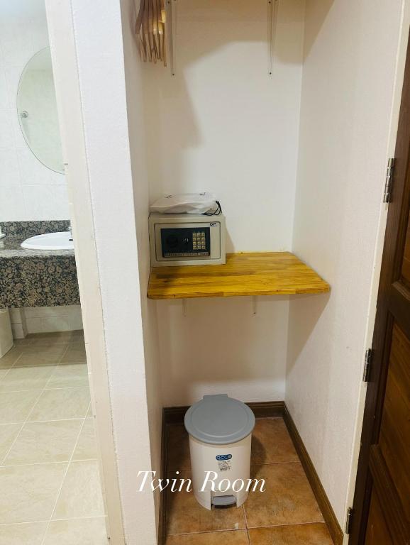 a microwave sitting on a shelf in a bathroom at Surin Bay Inn in Surin Beach