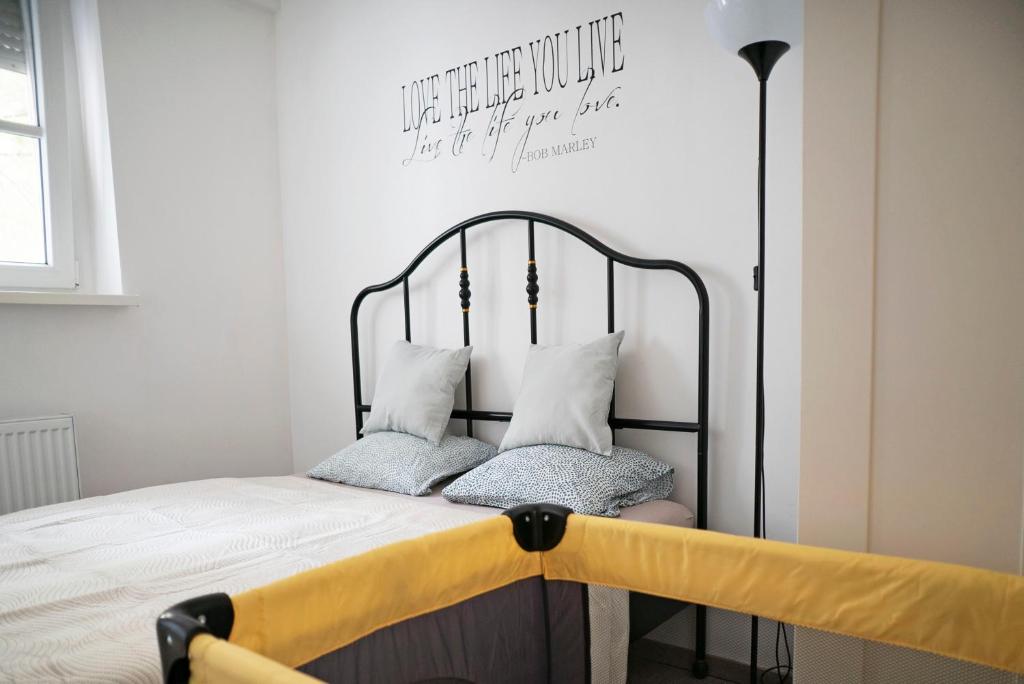 a bed with two pillows on it in a room at Cozy 2-room apt, Parking nearby in Staré Mesto