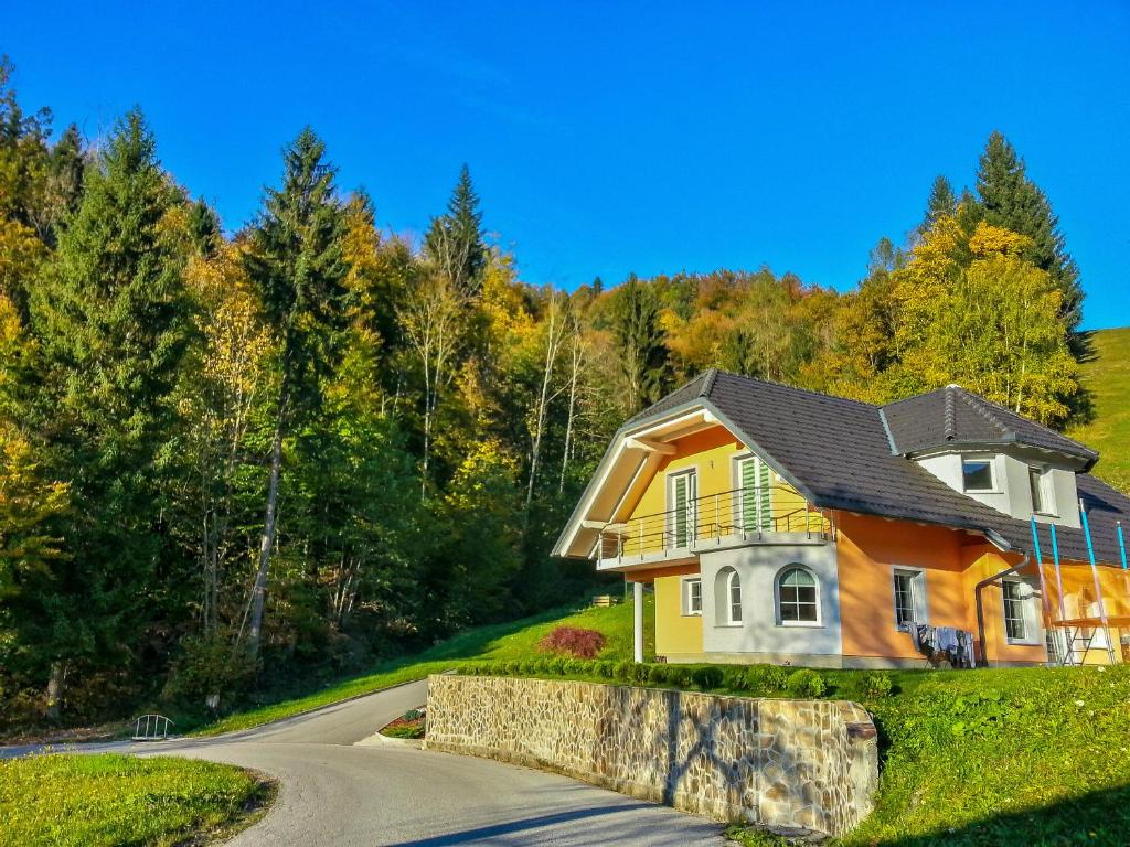 a house on a road in the woods at Apartment Ozebek in Cerkno