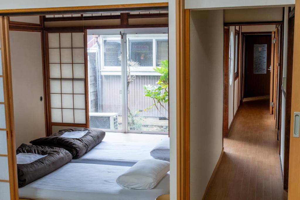 Postel nebo postele na pokoji v ubytování 永楽町House