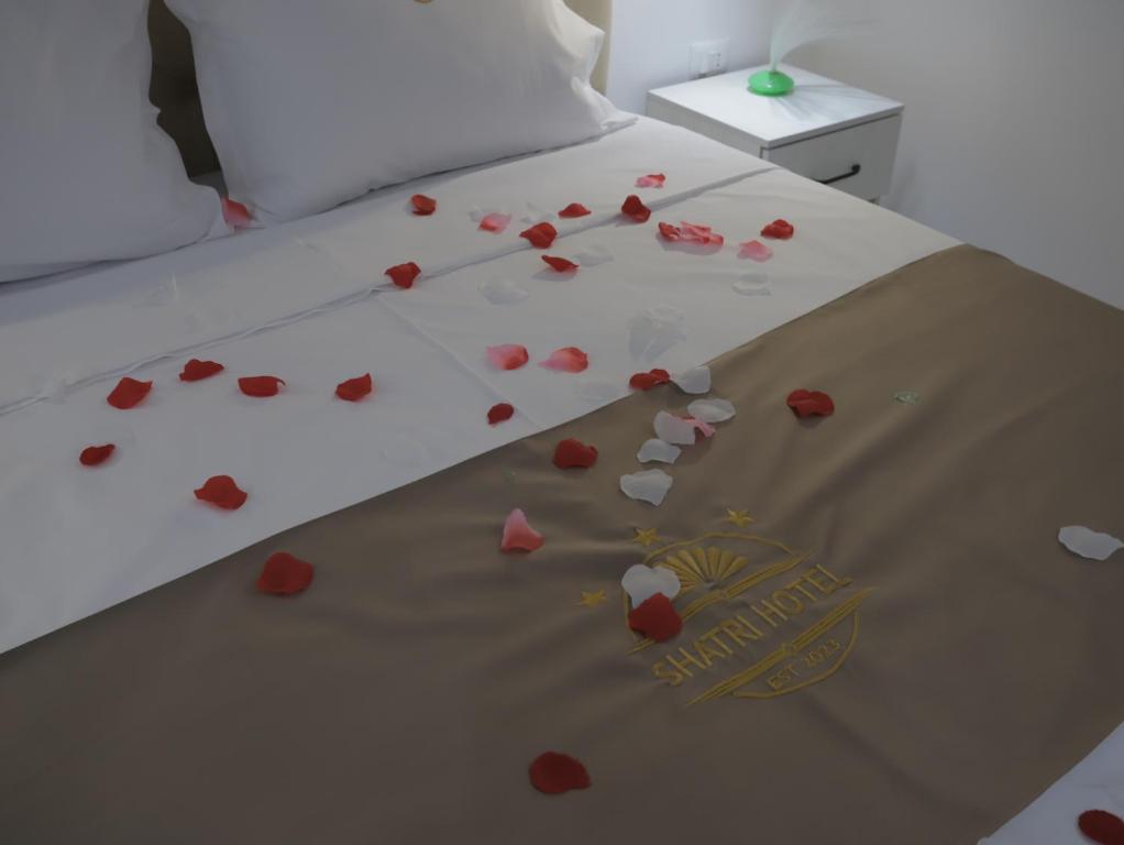 a bed with red hearts on it with a sheet at Shatri Hotel in Vranisht
