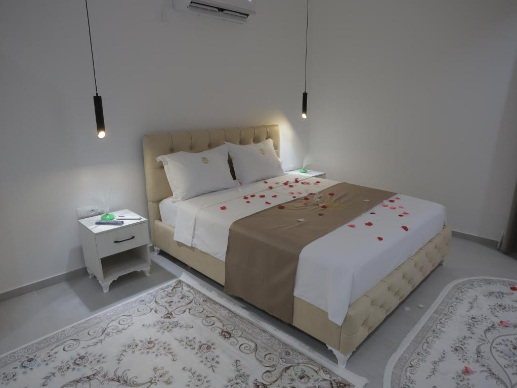 a bedroom with a large bed and a table at Shatri Hotel in Vranisht