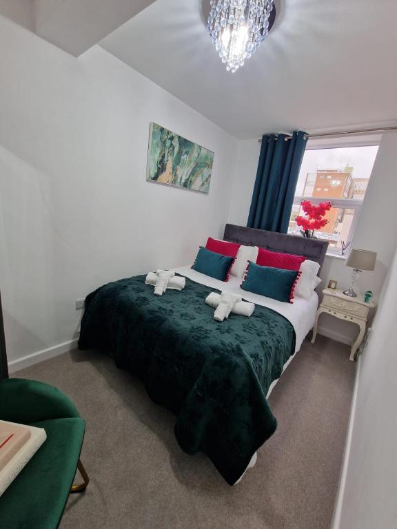 a bedroom with a bed with two teddy bears on it at 12 B Market Street in Watford