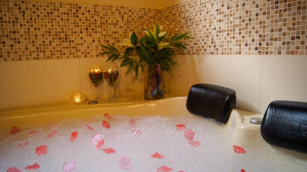 a bath tub filled with blood in a bathroom at Verde Mauá Chales in Visconde De Maua