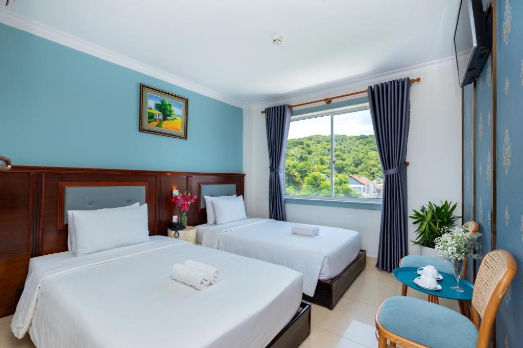 Giường trong phòng chung tại 3H GRAND HOTEL Vũng Tàu