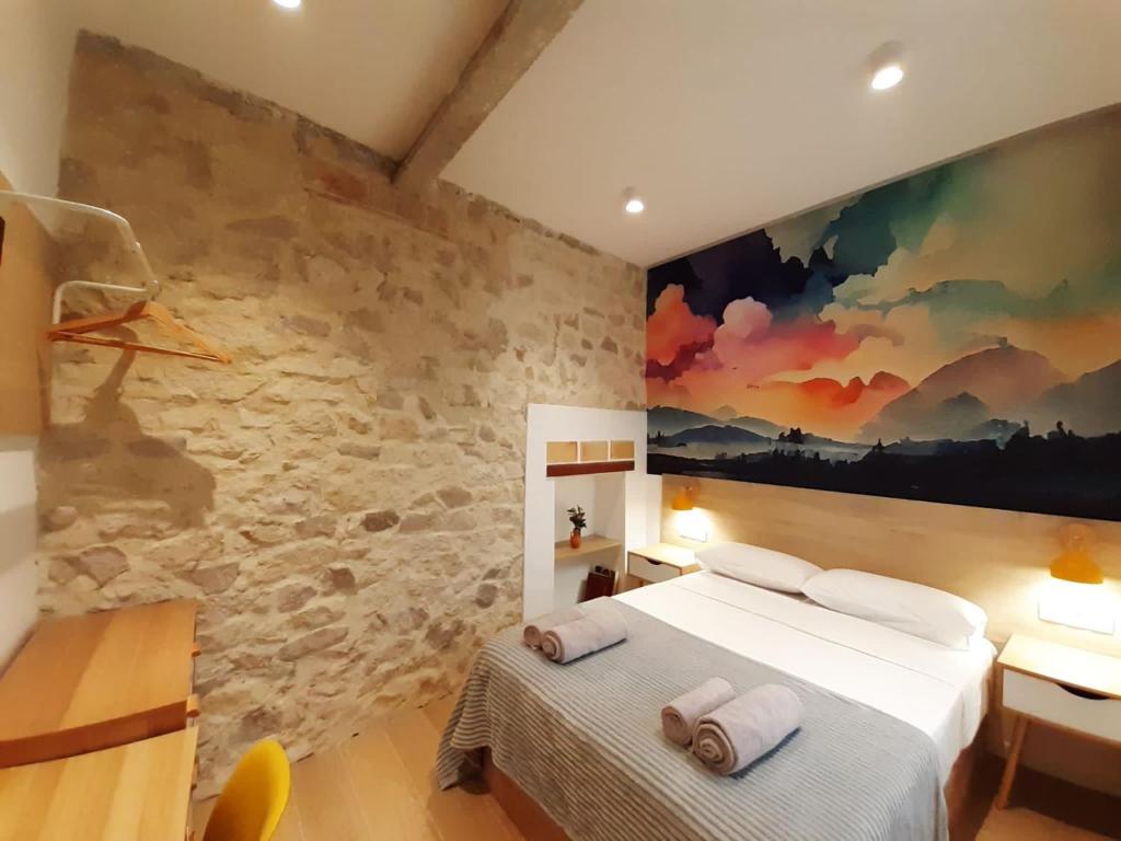 une chambre avec un lit et un tableau au mur dans l'établissement Good Energy Rooms, à Alicante
