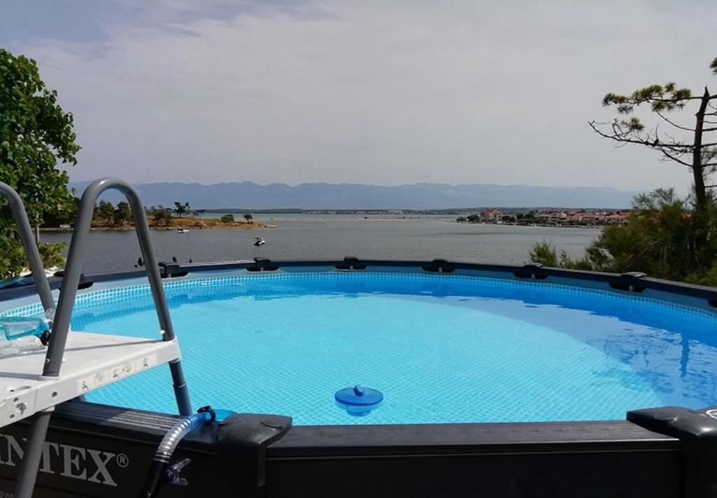 a swimming pool with a view of the water at Apartments Ljilja in Nin