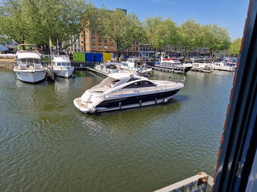 a boat is docked in a marina with other boats at Willemsbrug Vista in Schiedam