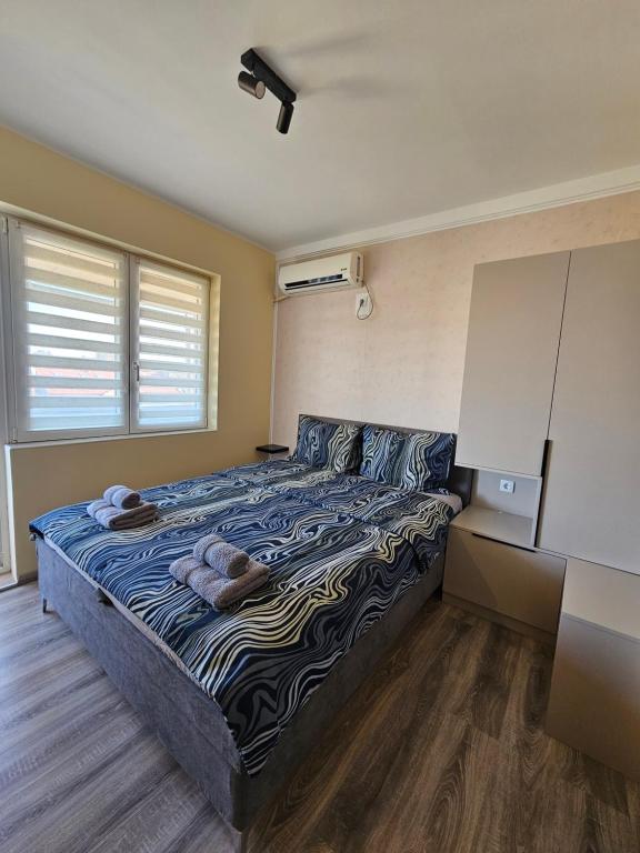 a bedroom with a large bed in a room at Apartman Slađa in Novi Sad