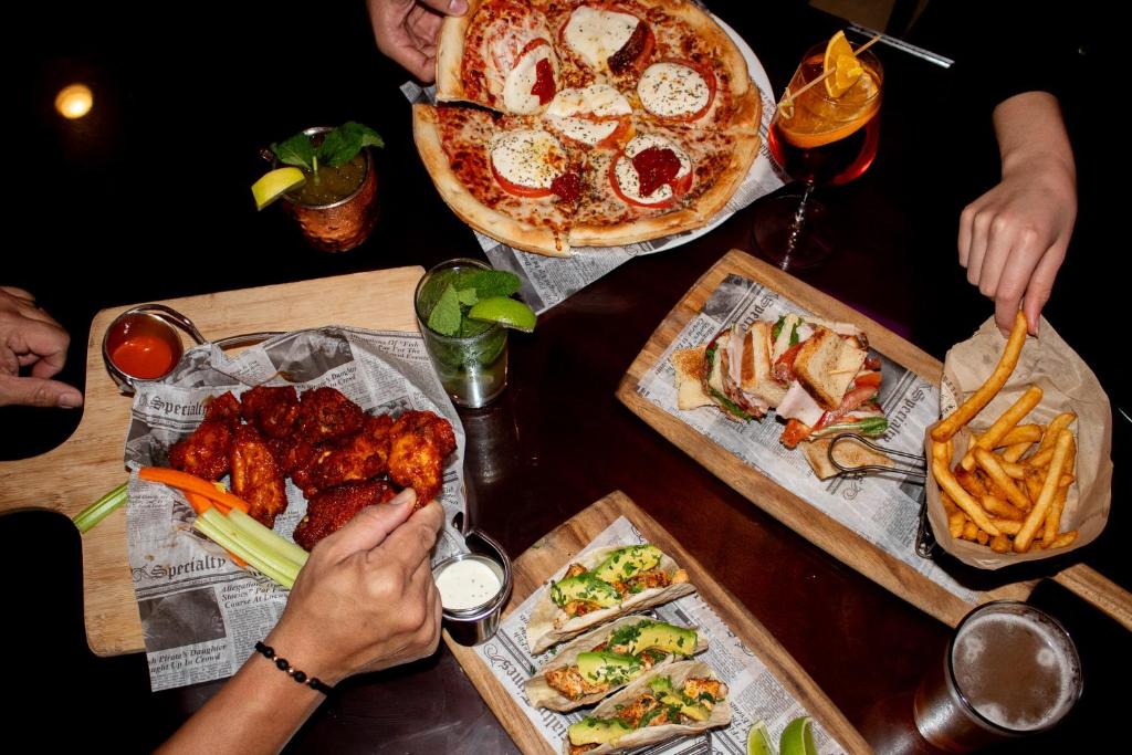 a table with plates of food and a pizza at Miami Marriott Dadeland in Miami