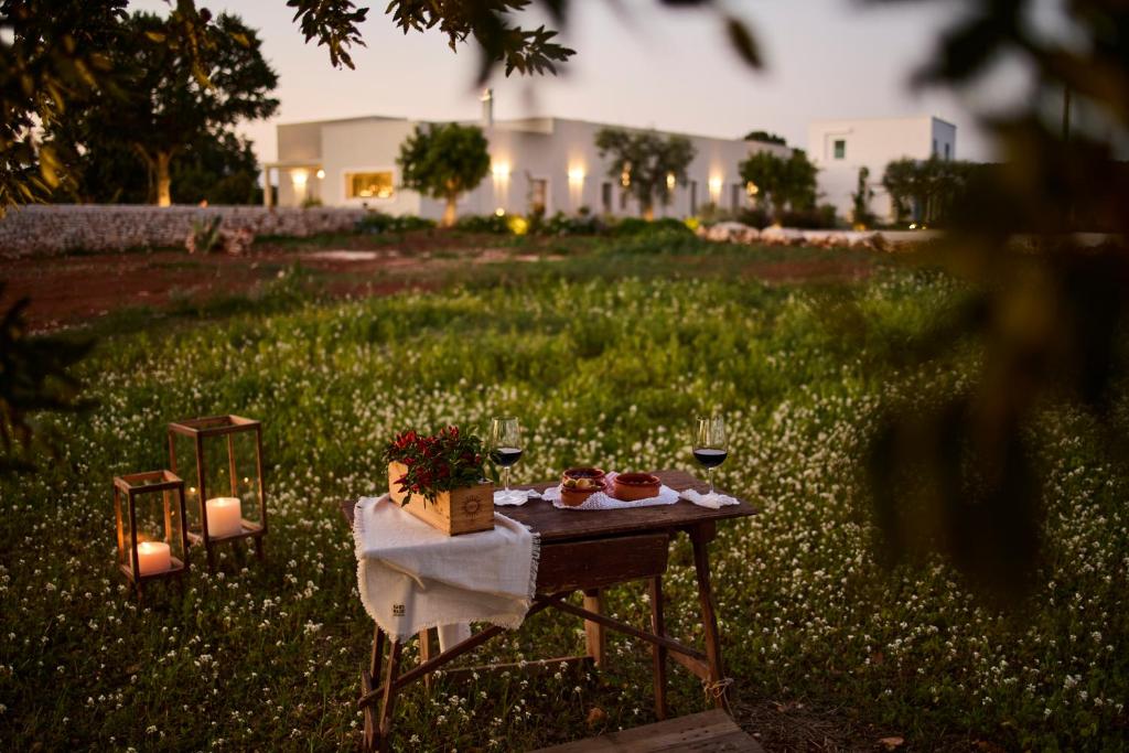 a table with food and candles on top of a field at Tenuta Giotta in Castellana Grotte