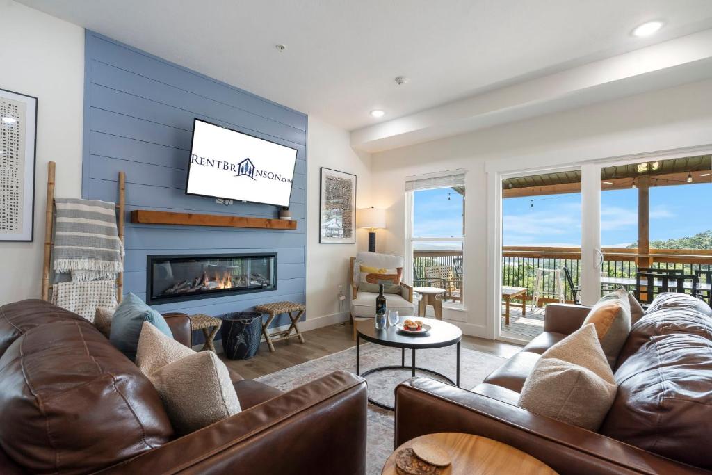a living room with a couch and a fireplace at Breathtaking Lake Views-Dog Friendly-$400 of Free Tickets-High End Decor in Branson