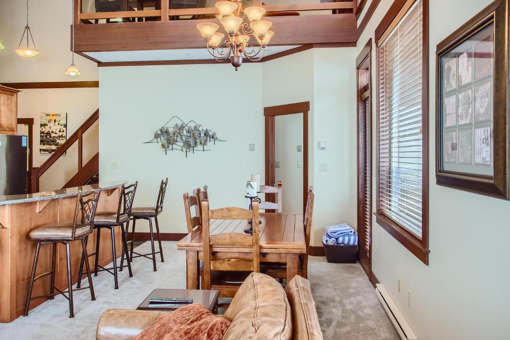 a living room with a couch and a table at Stonegate Resort Unit A401 in Big White
