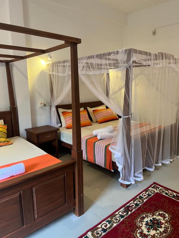 Postel nebo postele na pokoji v ubytování TEMBO Cottage Wilpattu
