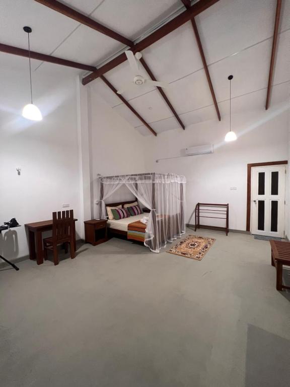 Postel nebo postele na pokoji v ubytování TEMBO Cottage Wilpattu