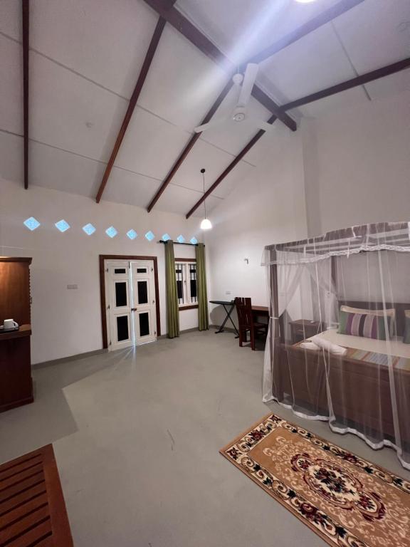 Postel nebo postele na pokoji v ubytování TEMBO Cottage Wilpattu