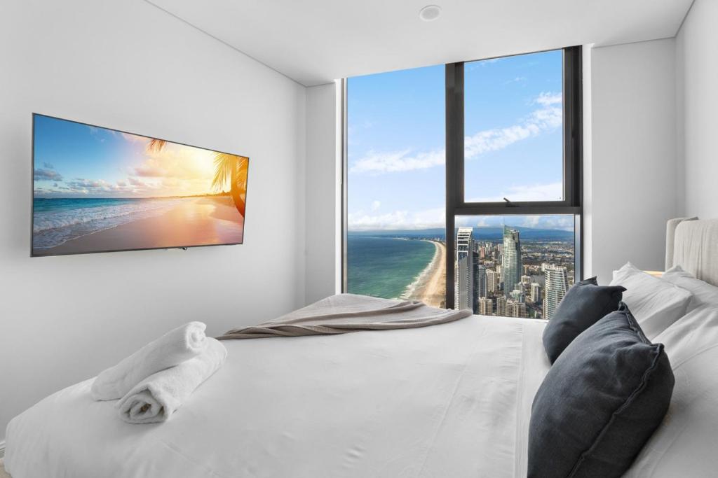 a bedroom with a large white bed with a large window at The Ocean - Beachfront 72F 3Bedroom Skyhome Ocean Views with Parking & Resort Facilities in Gold Coast