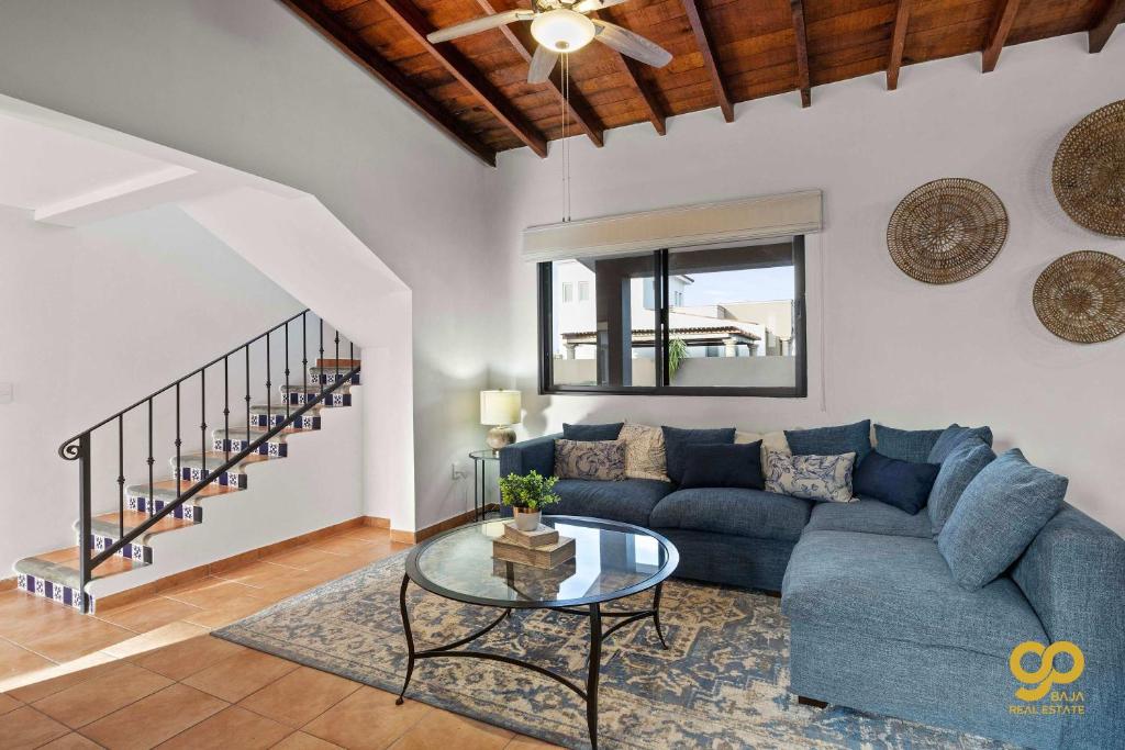 a living room with a blue couch and a glass table at El Centenario Fully-equipped Home Steps to Beach in El Centenario