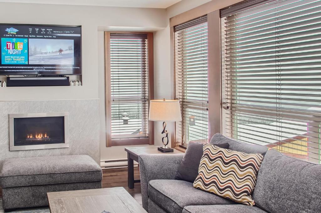 a living room with a couch and a tv at Stonegate Resort Unit B102 in Big White