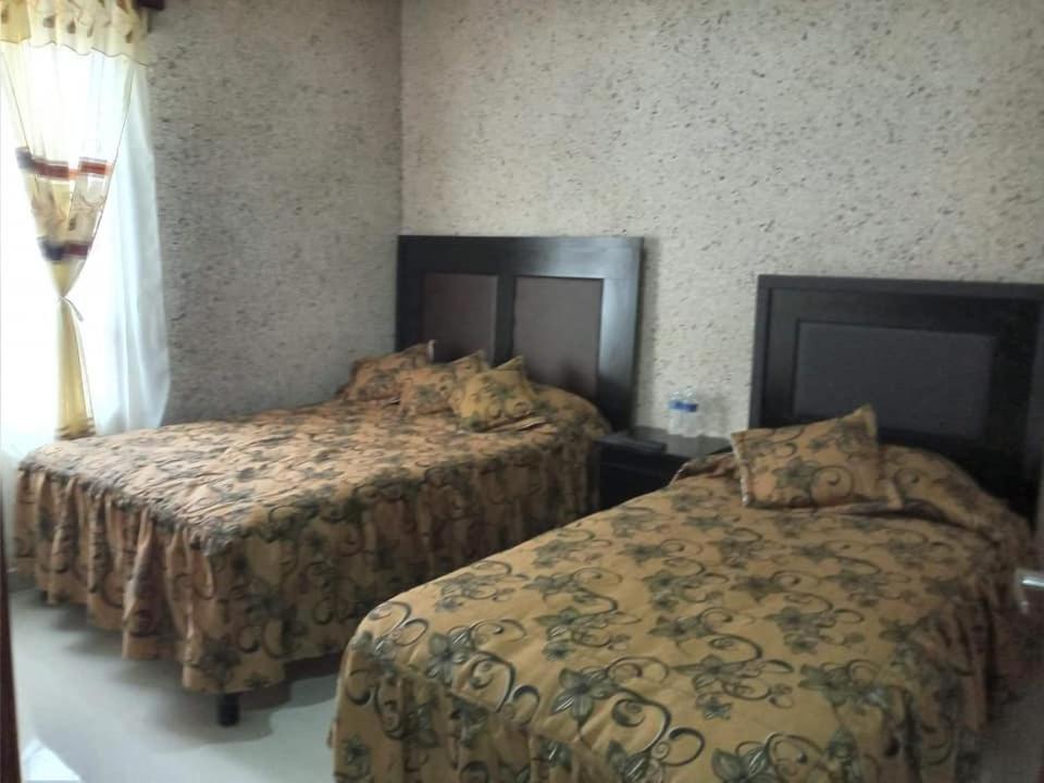 Postel nebo postele na pokoji v ubytování Hotel Guadalupe Bernal