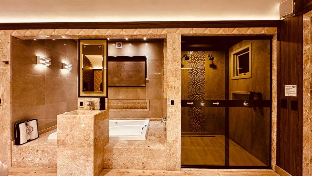 a bathroom with a shower and a sink and a toilet at Sensitive in Santo Antônio