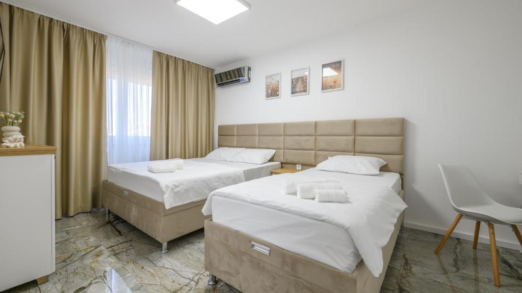 Postel nebo postele na pokoji v ubytování NAŠ Apartman