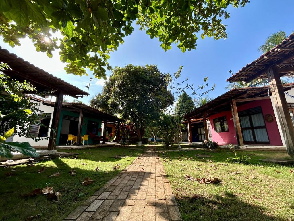 un sentiero di mattoni tra due edifici in un cortile di Chalés Praias Brasileiras a Maragogi