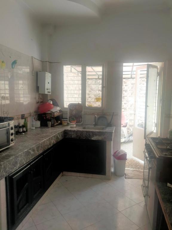 a kitchen with a sink and a counter top at Maison in Ville Nouvelle