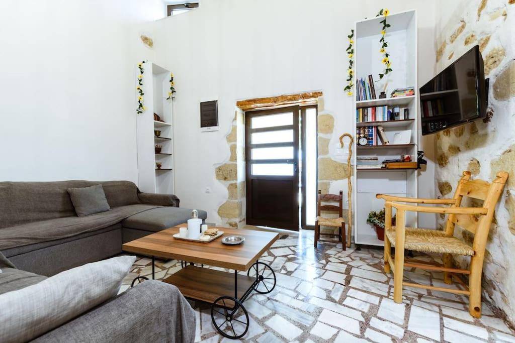 a living room with a couch and a table at Xanthippi's Traditional House in Pemonia in Pemónia