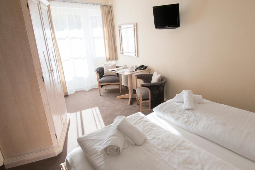 A bed or beds in a room at Crystls Aparthotel